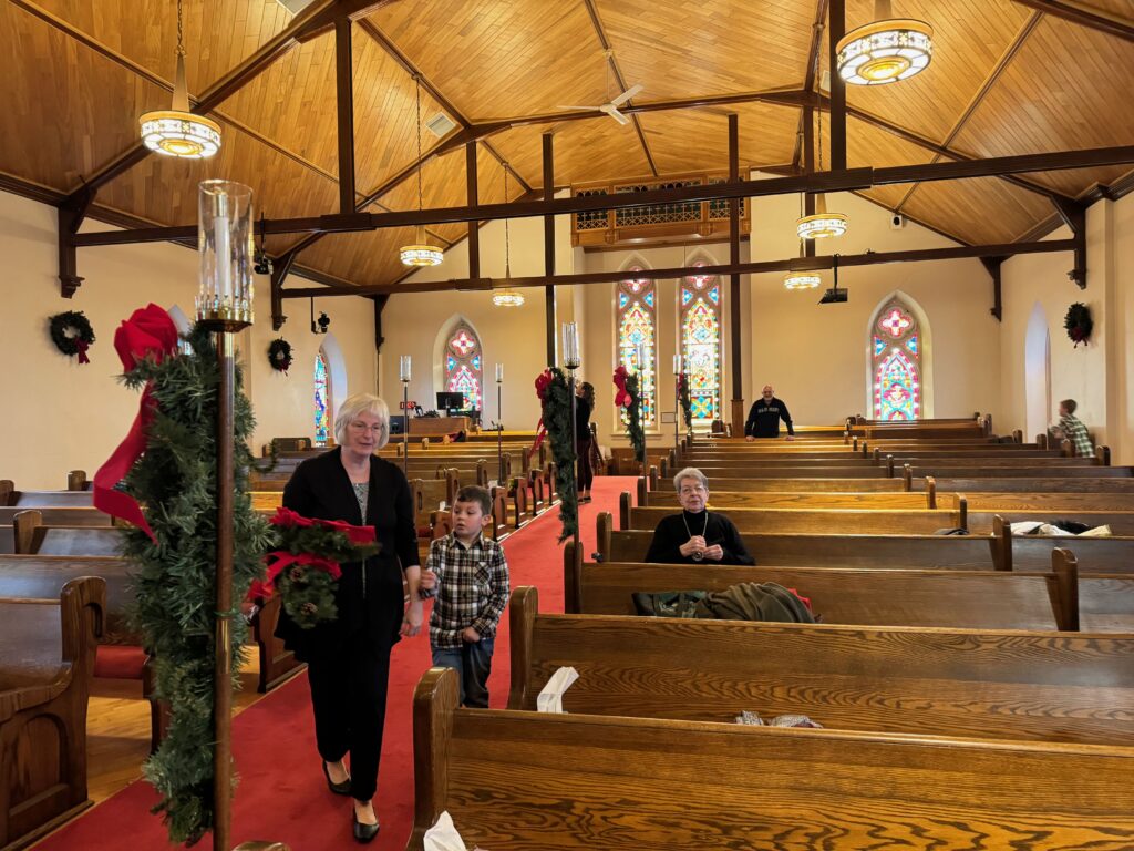 Church members decorating sanctuary for the seasons of Advent and Christmas in 2023